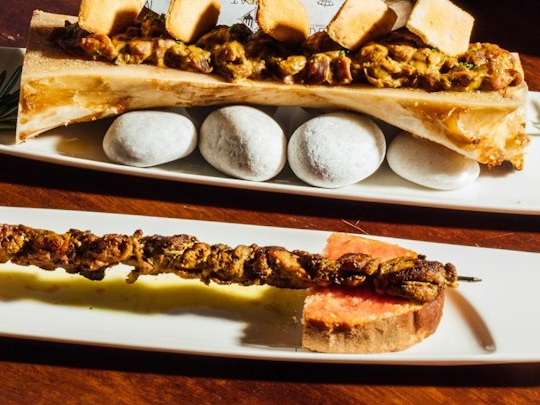 Roast bone marrow and a skewer on tomato bread