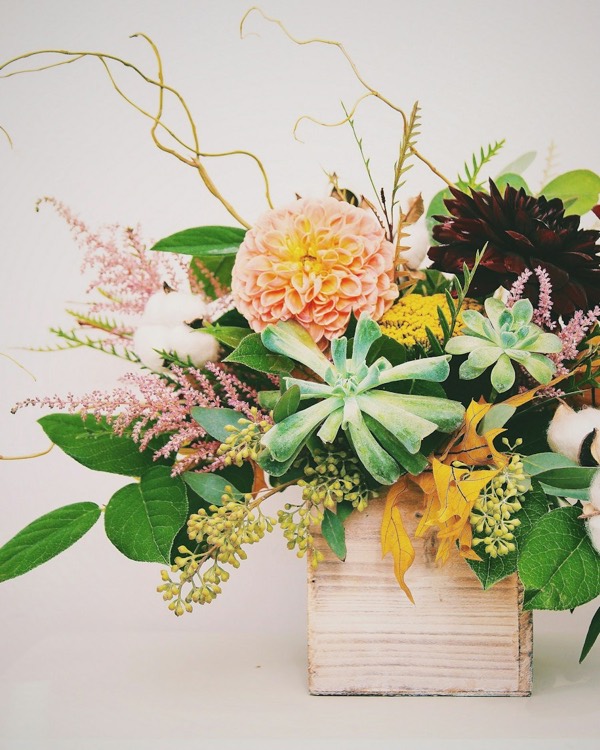 Arrangement of dahlias, succulents and astilbe in a wooden box
