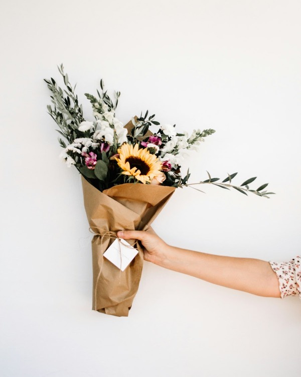 Seasonal bouquet with a sunflower and eucalyptus, wrapped in kraft paper