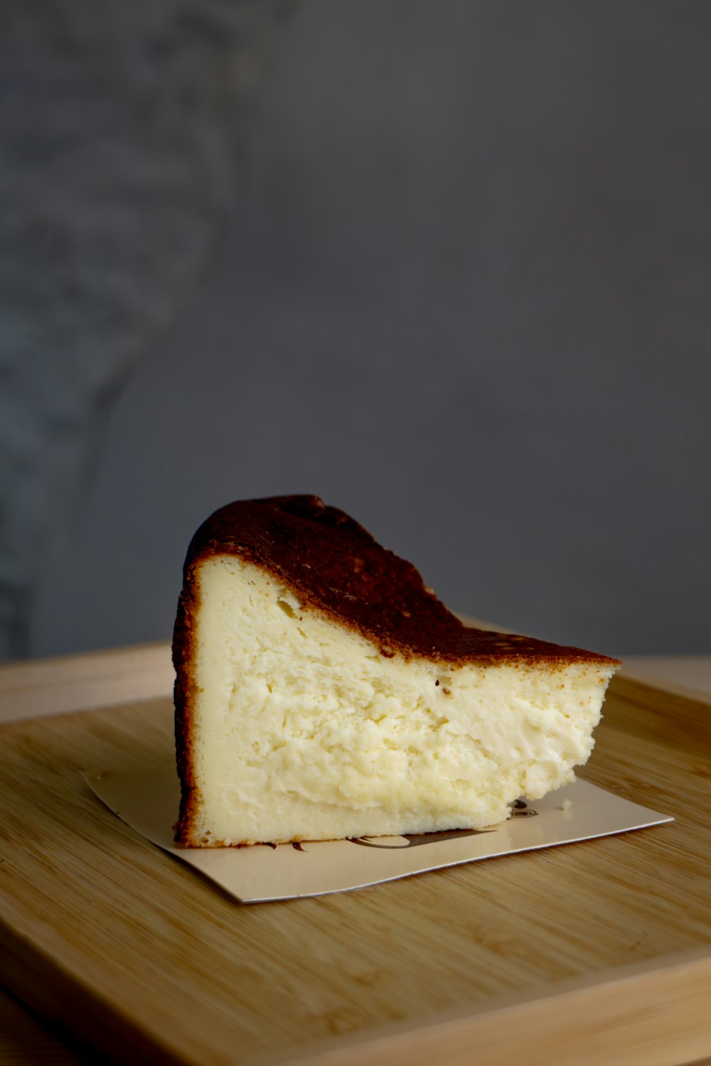 A slice of Basque cheesecake with a deeply browned top